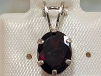 Front view of oval garnet pendant in sterling silver setting