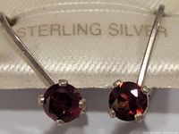 Close-up of garnet stones set in sterling silver prongs