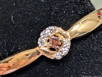 close-up of ring head showing lab diamond center and CZ halo