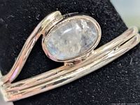 Front view of silver wrap ring with oval moonstone cabochon