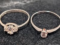 Both silver-tone rings side by side showing stone settings