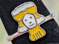 Front view showing enamel face motif and silver band