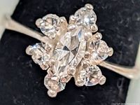 Close-up of cluster setting showing marquise and round clear stones