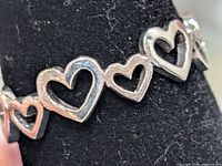 close-up of linked heart details on band