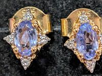 front view showing tanzanite centre stones, halo and 925 stamp on backs