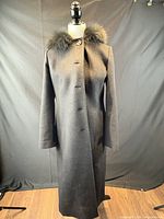 Front view of full-length black wool coat on mannequin