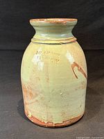 Full view of J.H. Ahrens stamped stoneware jug showing glaze color, shape and rim chips