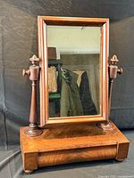 Full view of dresser mirror showing tilting rectangular mirror, turned supports, and single drawer base