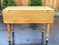 Front view of pine dropleaf table with both leaves down showing legs and apron