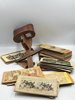 Viewer standing upright with stacks of stereo cards fanned out