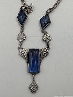 Close-up of pendant showing blue stones and floral sterling details