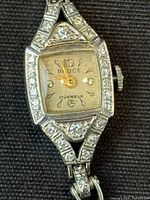 Close-up of dial, bezel, and stone accents