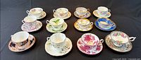 All 12 tea cup and saucer sets displayed