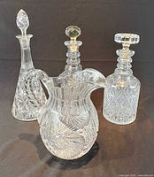 Four crystal pieces: three decanters, one pitcher