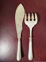 Front view of knife and fork showing chased decoration and handles