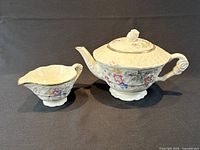 Teapot and creamer side by side