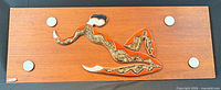 Front view showing full plaque, stylized dancer tiles, four white discs, signature tile bottom left