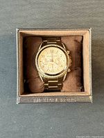 Watch in box with cushion and crystal bezel visible