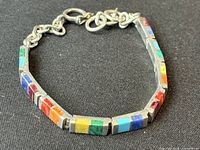 Full view of sterling silver bracelet with multi-colour stone inlay