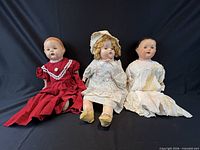 Front view of all three dolls seated