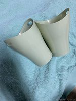 Two light green Umbra containers side by side