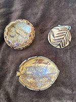 Three gourd items: carved bowl, ornament rattle, etched coconut bowl