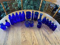 Group view of all cobalt blue glass pieces on table