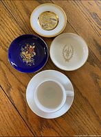 Top view showing all four saucers and cup