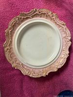 front view showing full design, pink and gold ornate rim