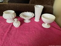 five white glass items front view