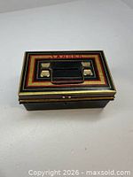 Top view showing decorative lid, handle and coin slot