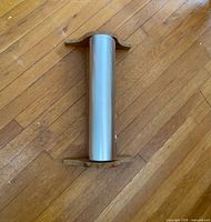 Aluminum foil roll mounted on wooden holder showing full item
