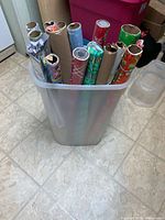 Front view of Rubbermaid tote with wrapping paper rolls inside