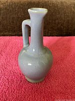 front view of pale blue ceramic vase showing overall shape and glaze