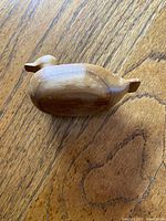 Profile view of small natural wood duck decoy