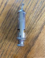 Full view of ACME City whistle showing maker’s stamp and overall condition