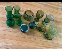 Group shot of all green glass pieces on floor