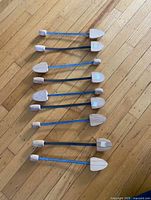 Nine vintage wood and metal shoe trees laid out showing full form and condition