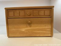 Front view of wooden bread box closed
