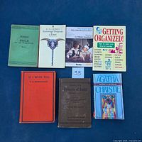 All seven books laid out front covers visible