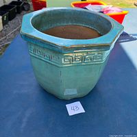 Front view of glazed ceramic planter showing shape and color