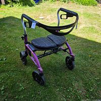 Right rear view of purple Evolution rollator walker on lawn
