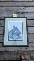 Full view of framed signed artwork