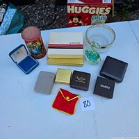 Group shot showing all items on table including jewelry boxes, glass dish and figurine