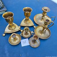 All six brass candlesticks displayed