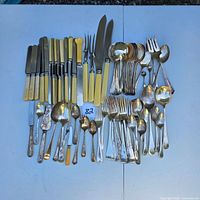 Full overhead view of entire flatware lot laid out on table