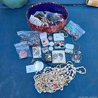 Entire lot laid out showing bowl, necklaces, boxes and bags