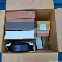 Box containing multiple rectangular slide tray boxes, loose black tray and yellow slide boxes