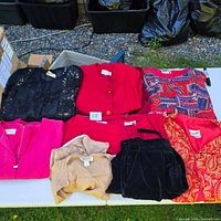Seven folded clothing items on table