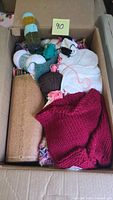 Box showing yarn, knitting needles in cork holder